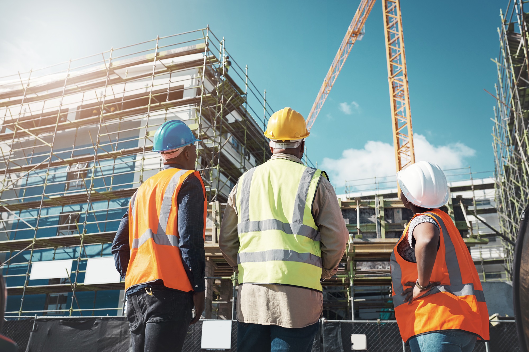Shot of a group of builders assessing progress at a construction site.